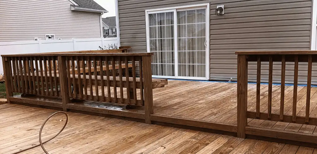 Deck sealing service protecting a backyard wood deck and railings in Sioux Falls, SD
