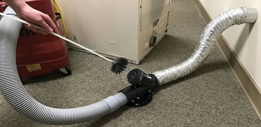 Dryer vent cleaning service removing lint from a dryer duct connection in Sioux Falls, SD