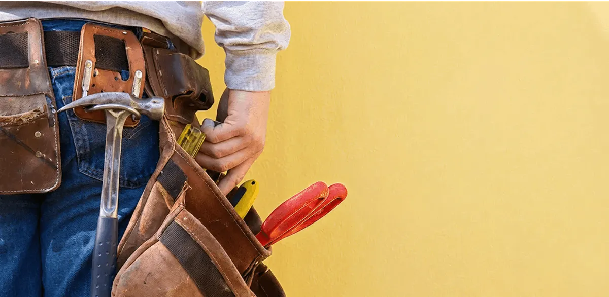 Handyman with tool belt ready for home repairs and maintenance in Sioux Falls, SD