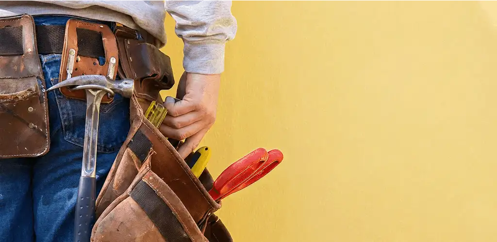 Handyman with tool belt ready for home repairs and maintenance in Sioux Falls, SD