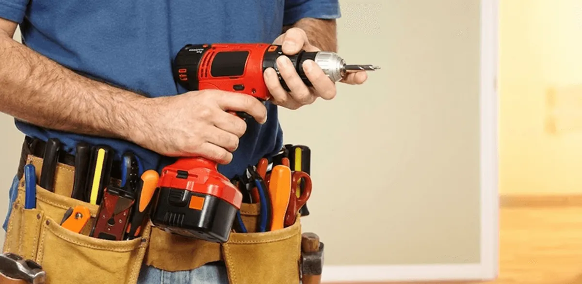 Handyman holding a power drill for home repairs and installations in Sioux Falls, SD