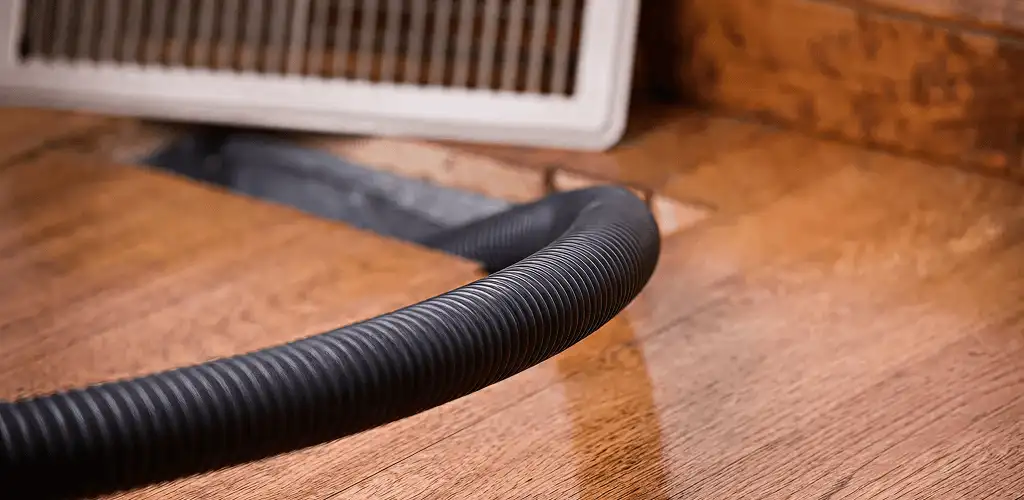 Air duct cleaning hose inserted into a floor vent for ductwork cleaning in Sioux Falls, SD