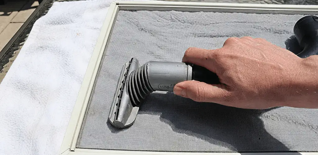 Window screen repair cleaning and fixing a damaged screen mesh in Sioux Falls, SD