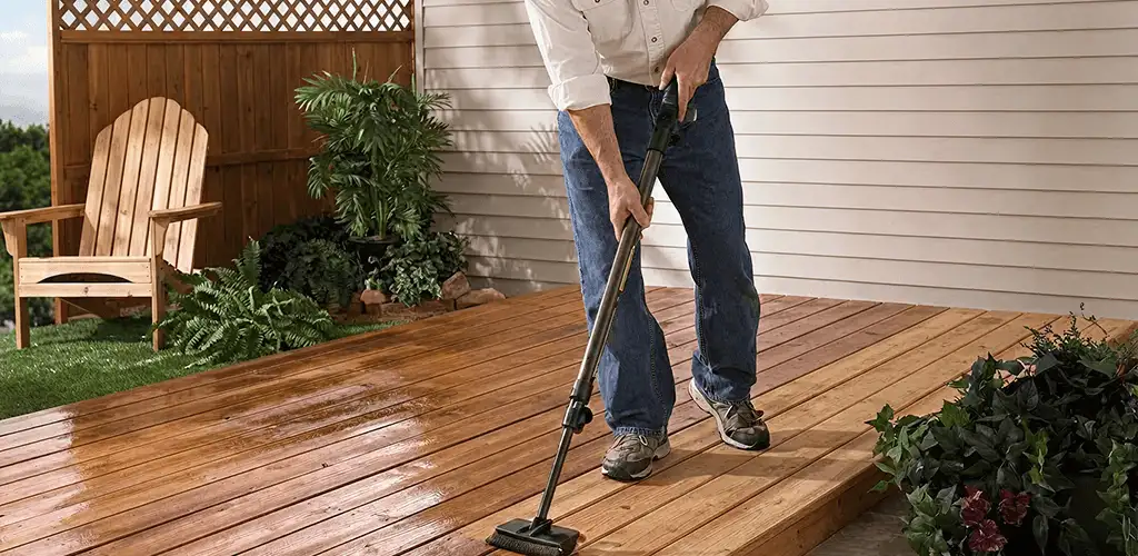 Deck staining service applying stain to a backyard wood deck in Sioux Falls, SD